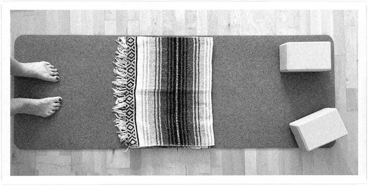 Photo of feet stepping on to a yoga mat, with blocks and a yoga blanket / Photo copyright Joy Stauber